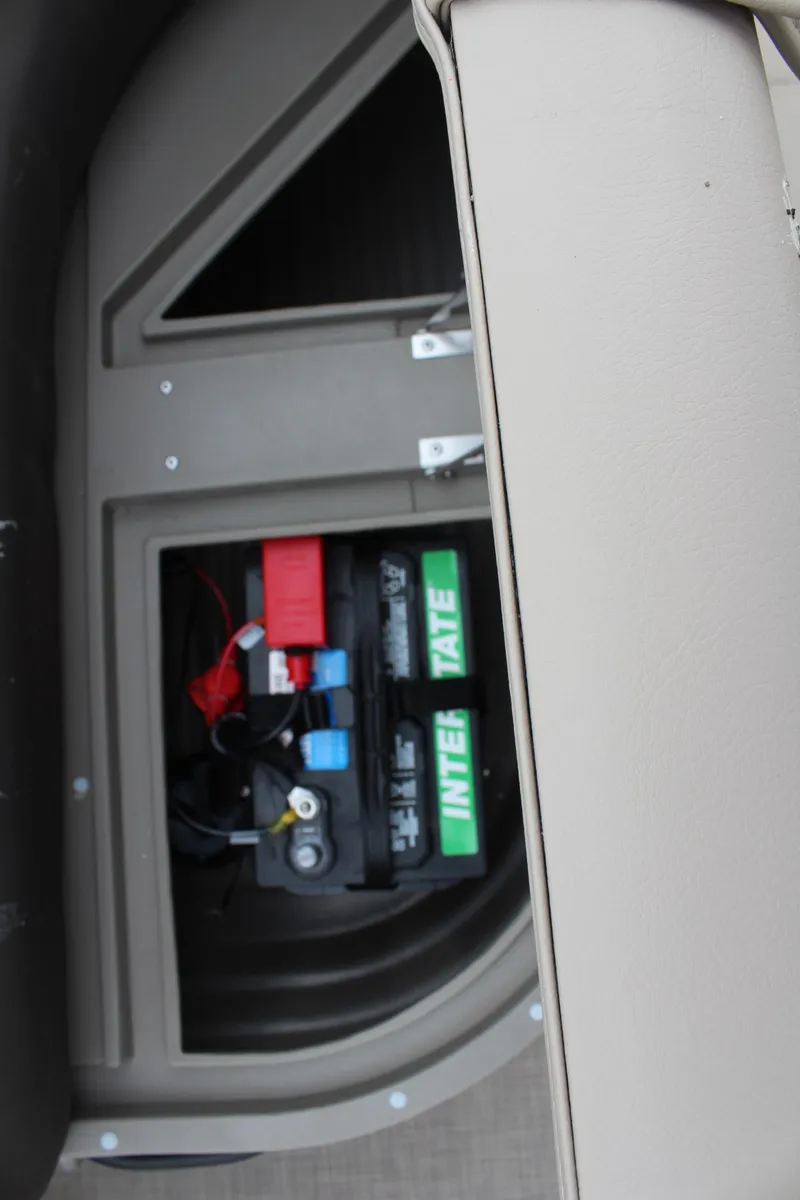Slide: The Image of 2025 Sun Tracker Party Barge 16 DLX battery compartment with visible wiring and components. - 14
