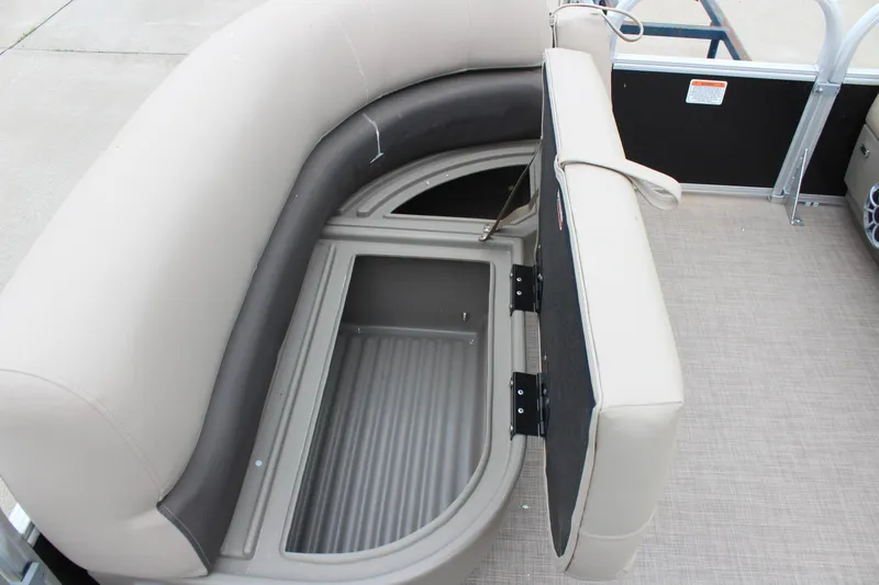 Slide: The Image of 2025 Sun Tracker Party Barge 16 DLX seating with storage compartment open. - 19