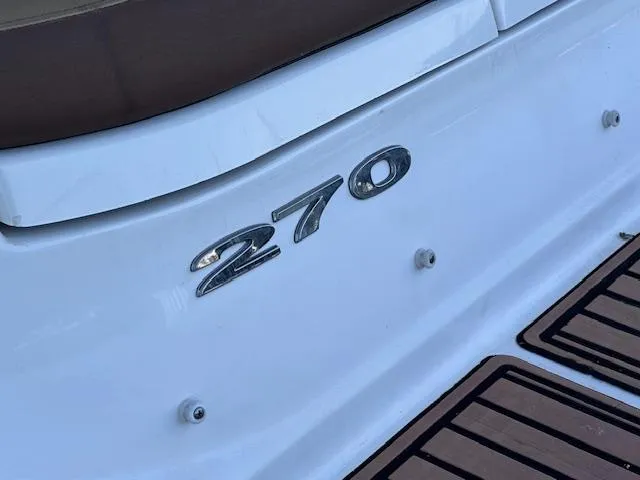 Slide: The Image of 2016 Sea Ray 270 Sundeck boat emblem on white hull. - 10