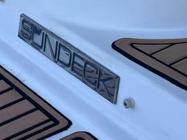 Slide: The Image of 2016 Sea Ray 270 Sundeck logo on boat deck with wood accents. - 11