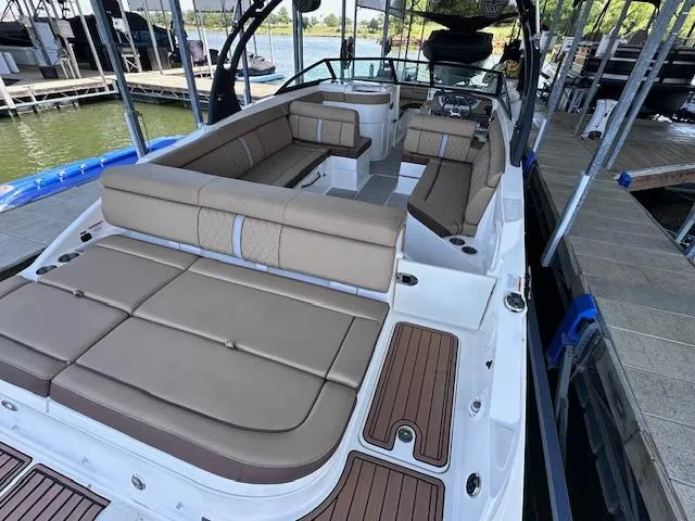 Slide: The Image of 2016 Sea Ray 270 Sundeck boat with spacious seating, docked at a marina. - 12