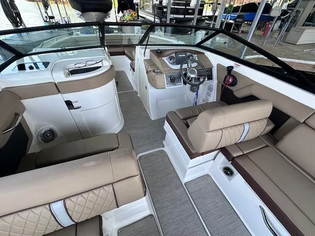 Slide: The Image of 2016 Sea Ray 270 Sundeck interior with beige seating and modern dashboard. - 15