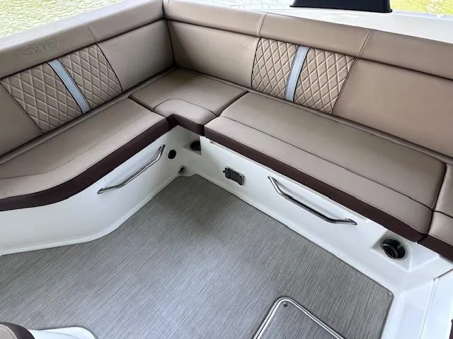 Slide: The Image of 2016 Sea Ray 270 Sundeck interior with beige and brown cushioned seating. - 22