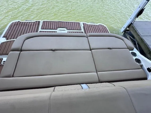 Slide: The Image of 2016 Sea Ray 270 Sundeck boat with cushioned seating and teak-style decking. - 23