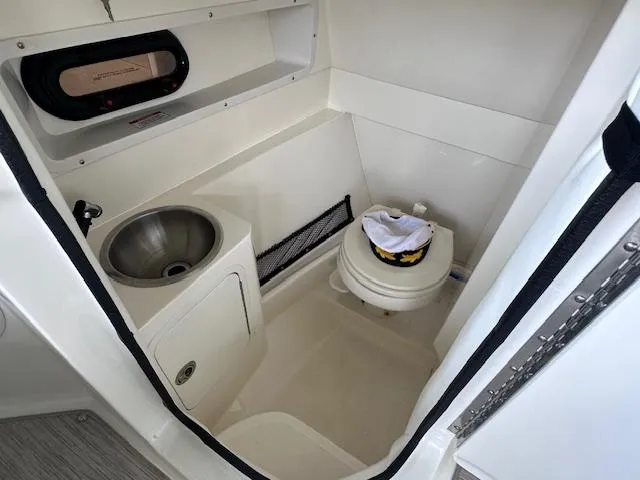 Slide: The Image of 2016 Sea Ray 270 Sundeck boat bathroom with sink and toilet. - 24