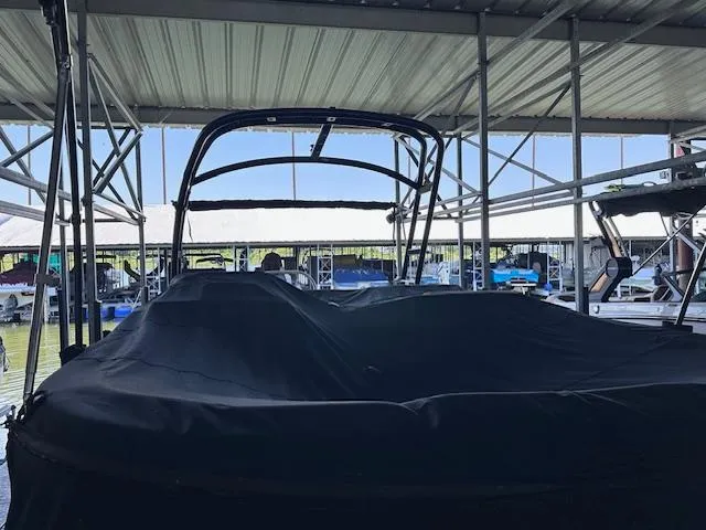 Slide: The Image of 2016 Sea Ray 270 Sundeck covered in a marina, under a metal roof. - 31