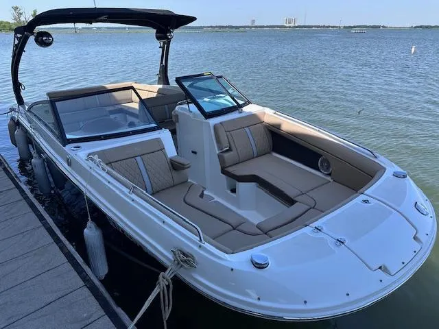 Slide: The Image of 2016 Sea Ray 270 Sundeck boat docked on calm water, featuring spacious seating and sleek design. - 32