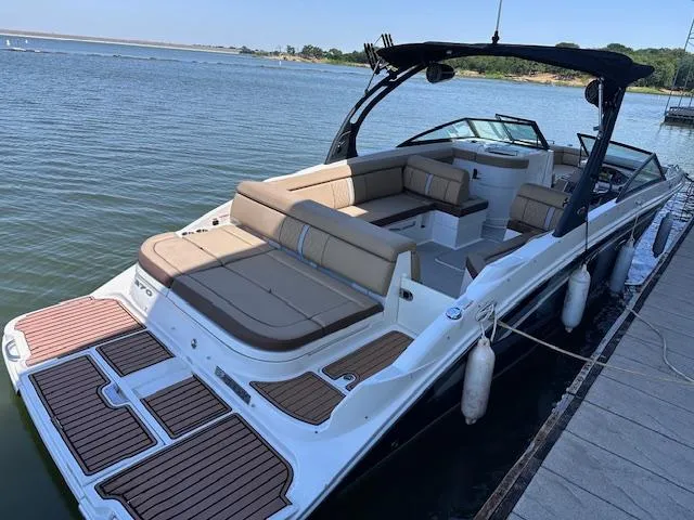 Slide: The Image of 2016 Sea Ray 270 Sundeck boat docked, featuring spacious seating and sleek design. - 33