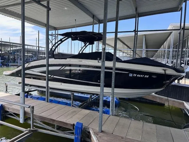 Slide: The Image of 2016 Sea Ray 270 Sundeck boat docked in a marina under a covered structure. - 36