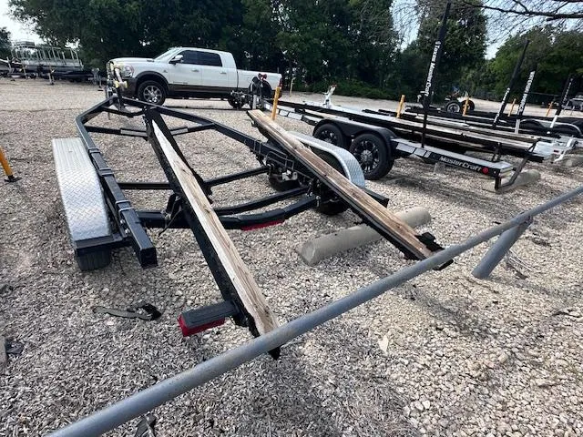 Slide: The Image of Trailer for 2016 Sea Ray 270 Sundeck on gravel lot, with parked vehicles nearby. - 40