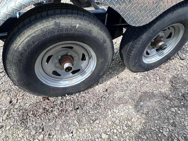 Slide: The Image of Trailer wheels for 2016 Sea Ray 270 Sundeck on gravel surface. - 41