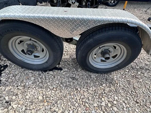 Slide: The Image of Trailer wheels for 2016 Sea Ray 270 Sundeck on gravel surface. - 42