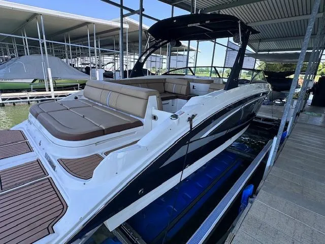 Slide: The Image of 2016 Sea Ray 270 Sundeck boat docked, featuring spacious seating and sleek design. - 7