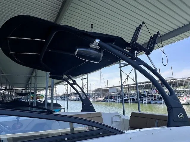 Slide: The Image of 2016 Sea Ray 270 Sundeck boat docked under a covered marina. - 9