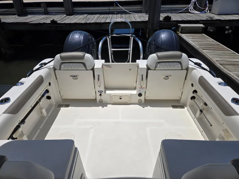 Slide: The Image of 2021 World Cat 255C boat interior with seating and dual engines at dock. - 11