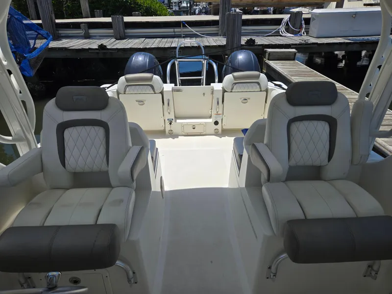 Slide: The Image of 2021 World Cat 255C boat interior with cushioned seating and dual outboard motors. - 12