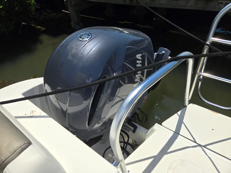 Slide: The Image of Outboard motor on 2021 World Cat 255C boat, docked in water. - 16