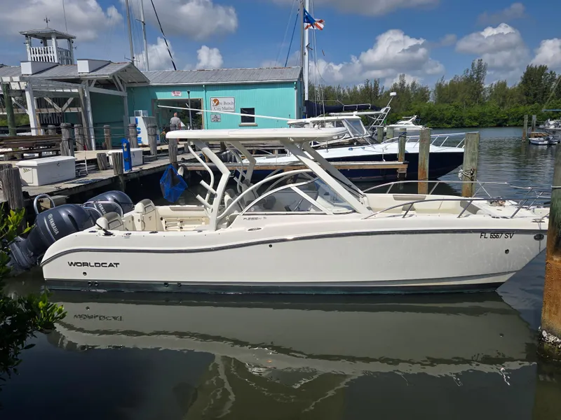 Slide: The Image of 2021 World Cat 255C boat docked at marina under blue sky. - 21