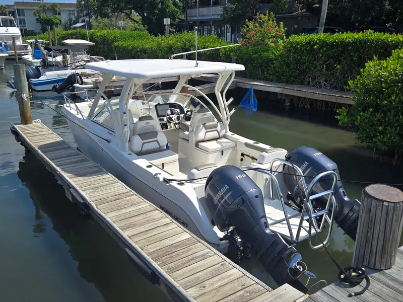 Slide: The Image of 2021 World Cat 255C boat docked with dual Yamaha engines, white exterior. - 23