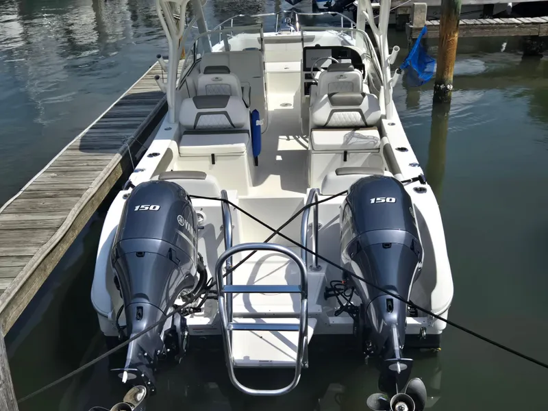 Slide: The Image of 2021 World Cat 255C boat with dual 150 horsepower engines docked at marina. - 24