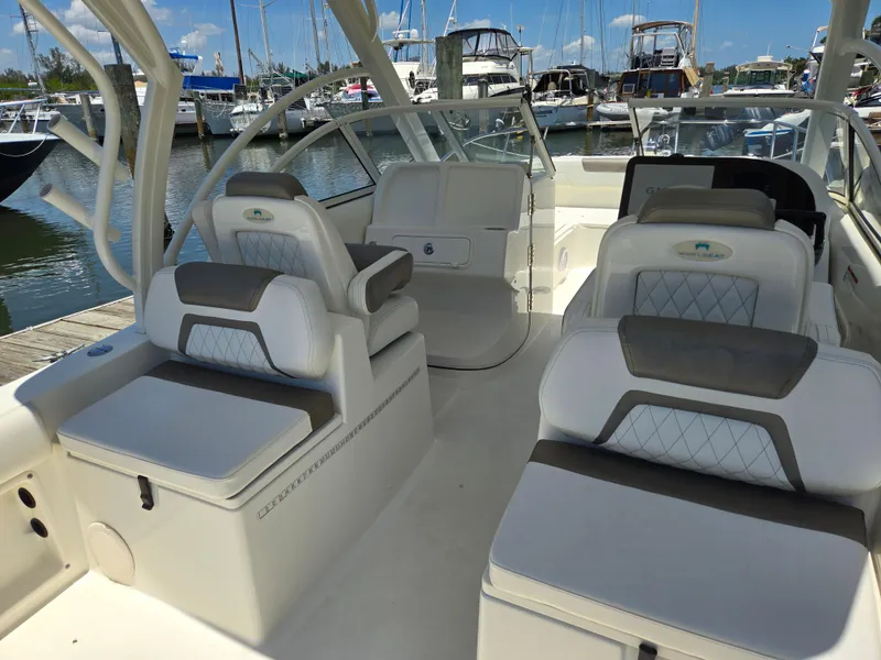 Slide: The Image of 2021 World Cat 255C boat interior with luxurious seating at marina. - 5