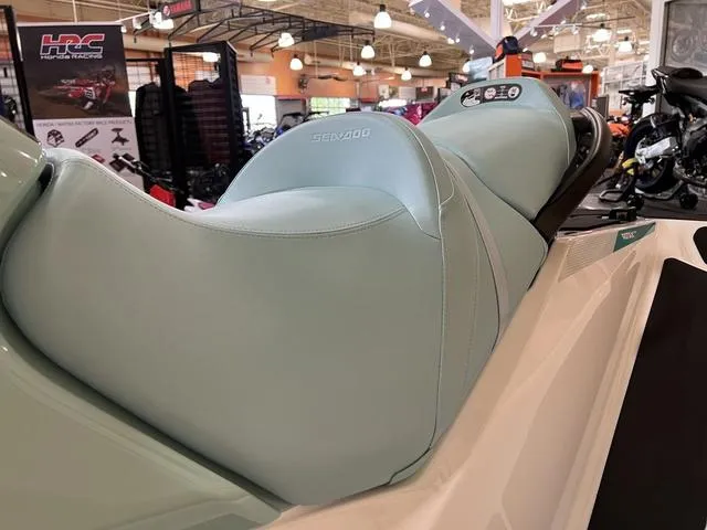 Slide: The Image of 2025 Sea-Doo Waverunner GTI with light blue seating in showroom. - 12