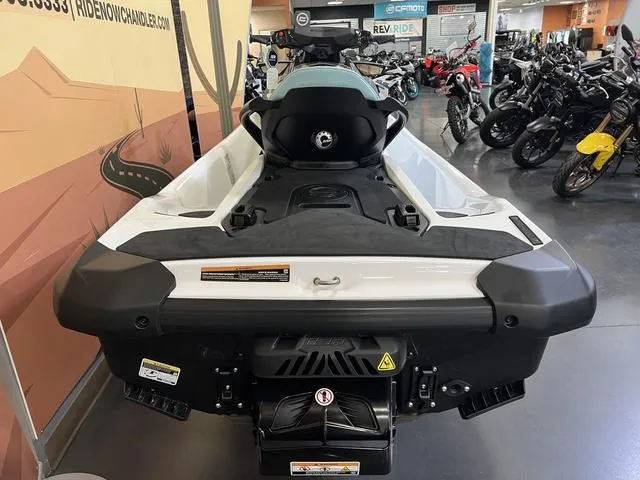 Slide: The Image of 2025 Sea-Doo Waverunner GTI in showroom, rear view, surrounded by motorcycles. - 5