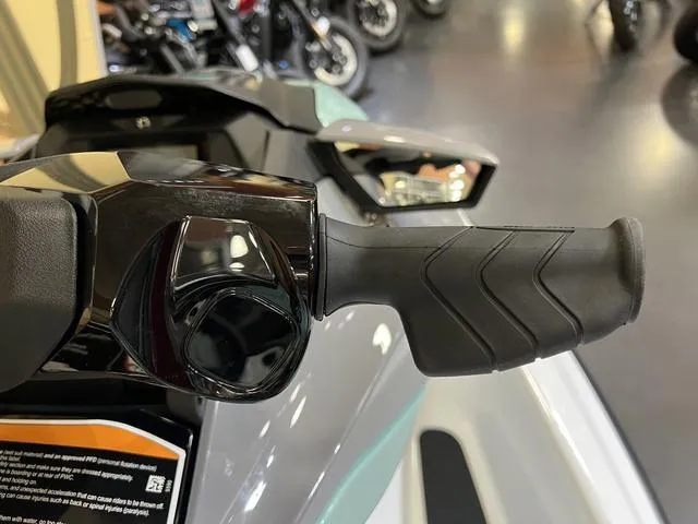 Slide: The Image of 2025 Sea-Doo Waverunner GTI handlebar close-up in showroom setting. - 9