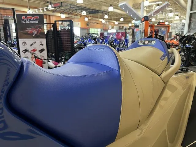 Slide: The Image of 2025 Sea-Doo Waverunner Wake with blue and beige seating in showroom. - 13