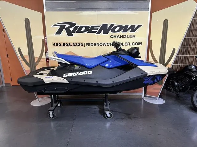 Slide: The Image of 2025 Sea-Doo Waverunner Spark Trixx, blue and black, side view. - 1