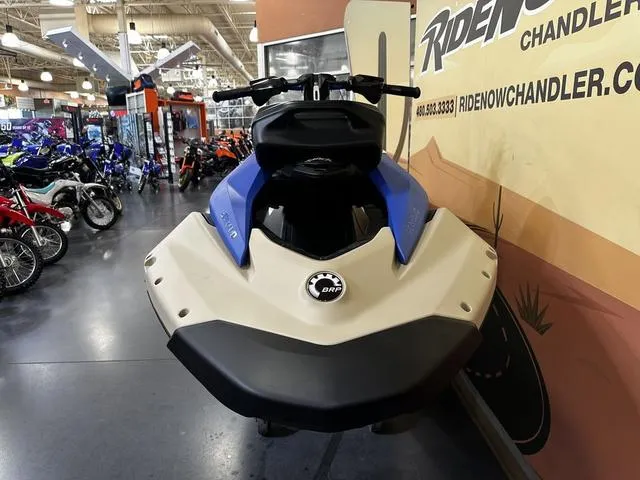 Slide: The Image of 2025 Sea-Doo Spark Trixx Waverunner displayed in showroom, front view. - 3
