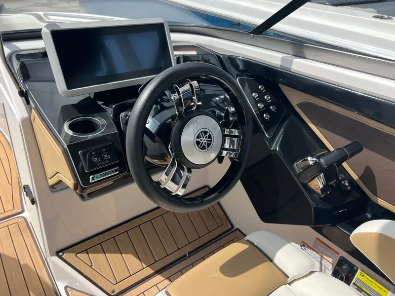 Slide: The Image of 2021 Yamaha Boats 252SE cockpit with modern steering wheel and digital display. - 10
