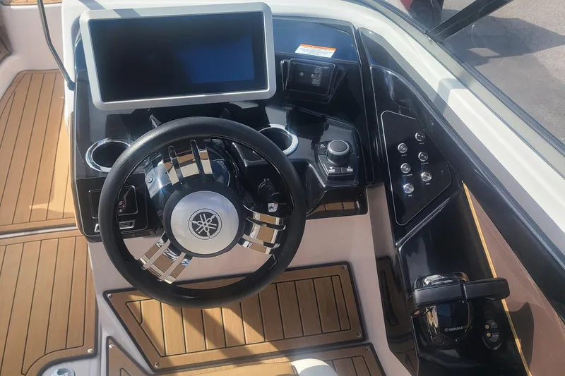 Slide: The Image of 2021 Yamaha Boats 252SE dashboard with steering wheel and touchscreen display. - 11