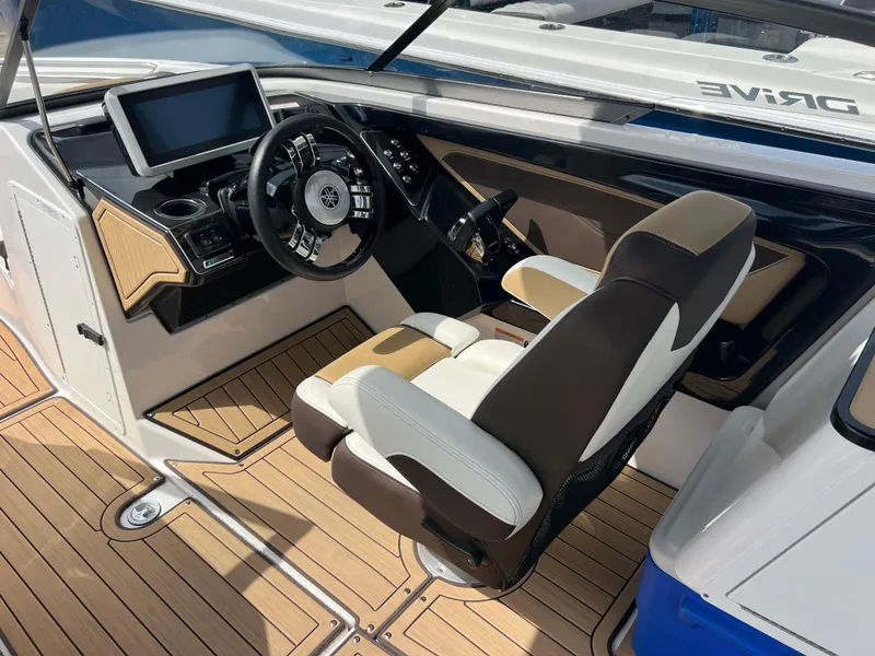 Slide: The Image of 2021 Yamaha Boats 252SE cockpit with modern steering and dashboard design. - 13