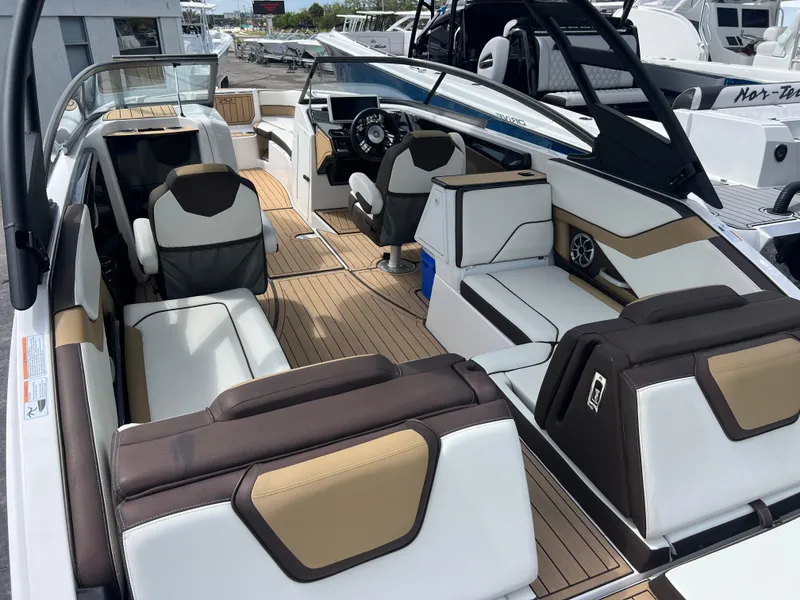Slide: The Image of 2021 Yamaha Boats 252SE interior with luxurious seating and modern dashboard. - 16