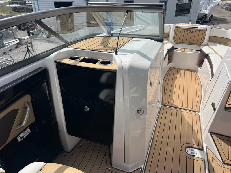 Slide: The Image of 2021 Yamaha Boats 252SE interior with sleek wood finish and modern design. - 21