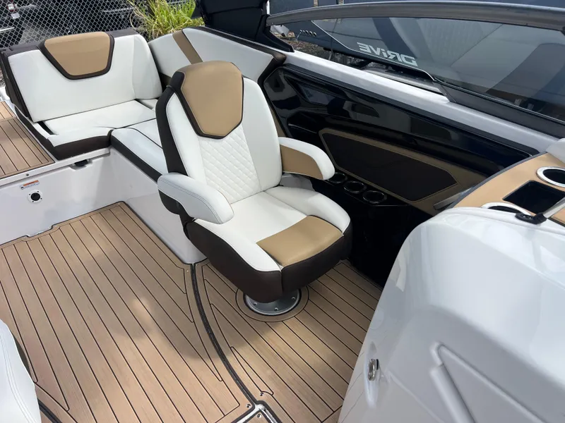 Slide: The Image of 2021 Yamaha Boats 252SE interior with luxurious seating and sleek design. - 26
