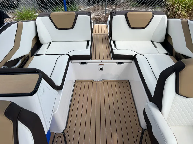 Slide: The Image of 2021 Yamaha Boats 252SE interior with white and tan seating, featuring sleek design and spacious layout. - 27