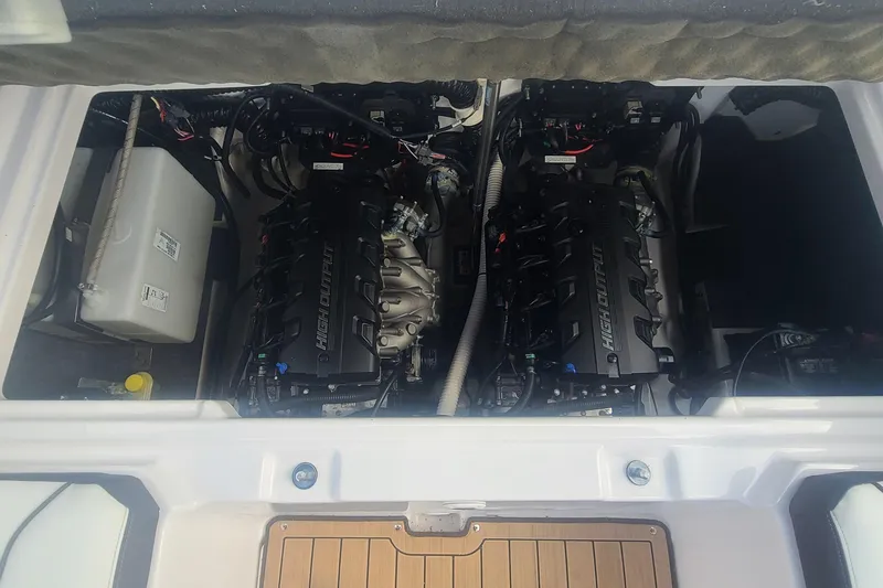Slide: The Image of Engine compartment of a 2021 Yamaha Boats 252SE, showcasing dual engines and components. - 28