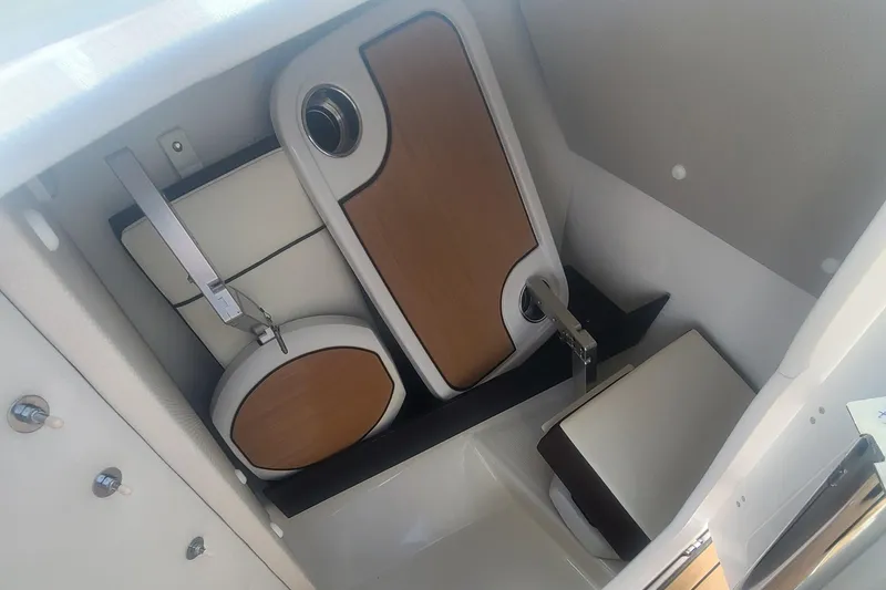 Slide: The Image of 2021 Yamaha Boats 252SE storage compartment with neatly organized accessories. - 34