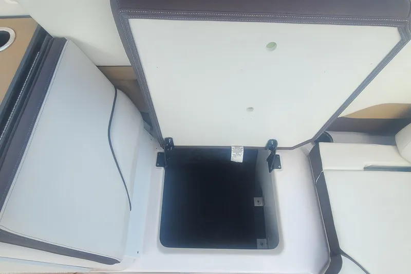 Slide: The Image of 2021 Yamaha Boats 252SE storage compartment with open lid, showcasing interior space. - 37
