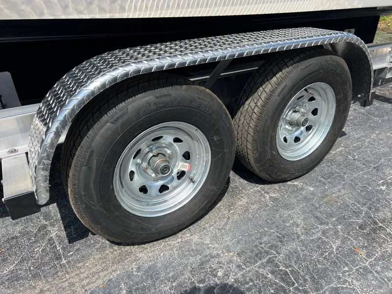 Slide: The Image of Trailer wheels for 2021 Yamaha Boats 252SE, featuring dual tires and metal fenders. - 40
