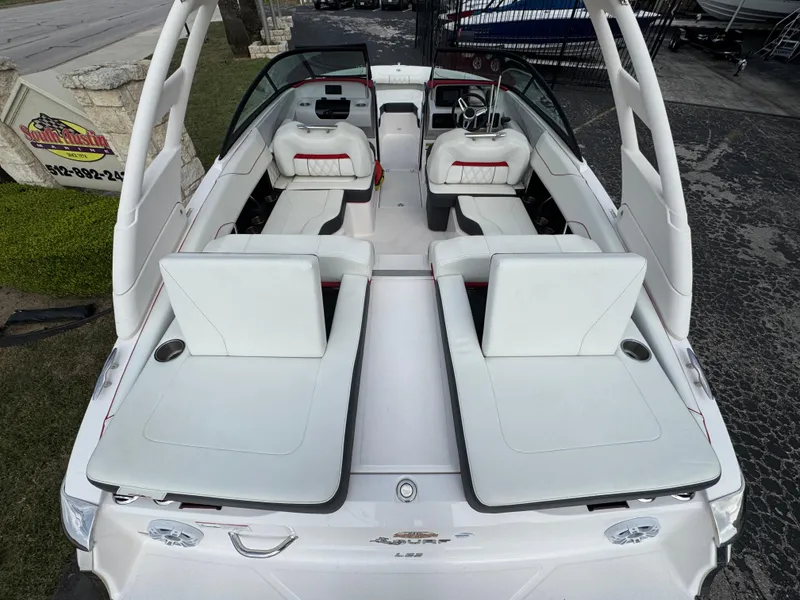 Slide: The Image of 2020 Regal LS2 Surf boat with white seating and sleek interior design. - 10