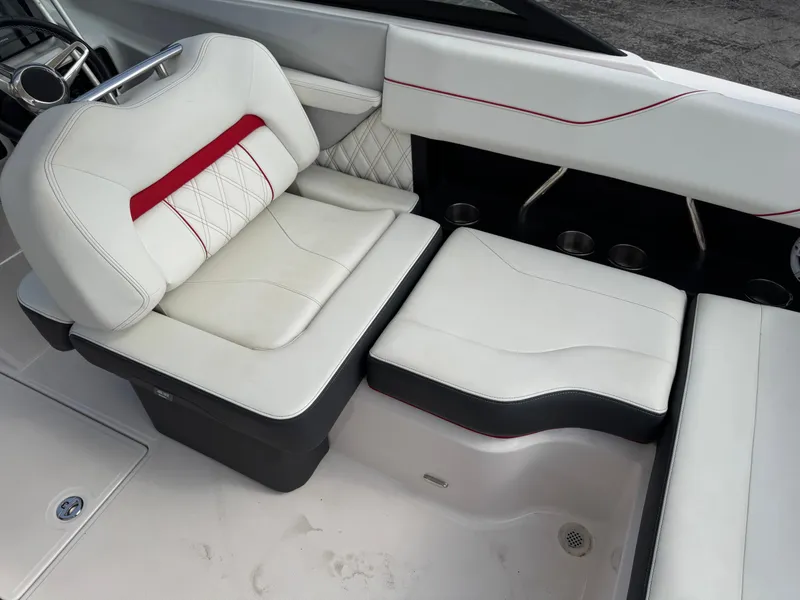 Slide: The Image of 2020 Regal LS2 Surf boat interior with white leather seating and red accents. - 13