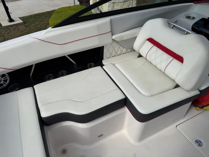 Slide: The Image of 2020 Regal LS2 Surf boat interior with white and red cushioned seating. - 14