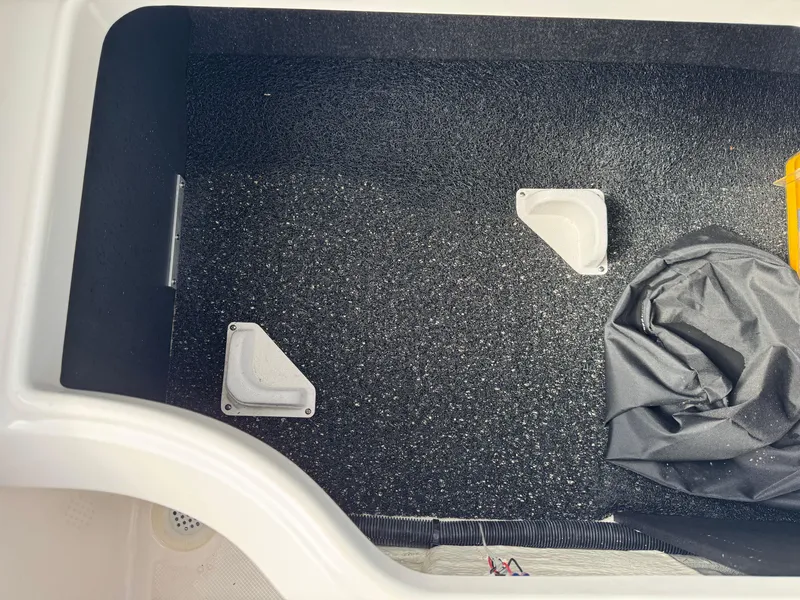 Slide: The Image of 2020 Regal LS2 Surf boat interior storage compartment with textured flooring. - 15