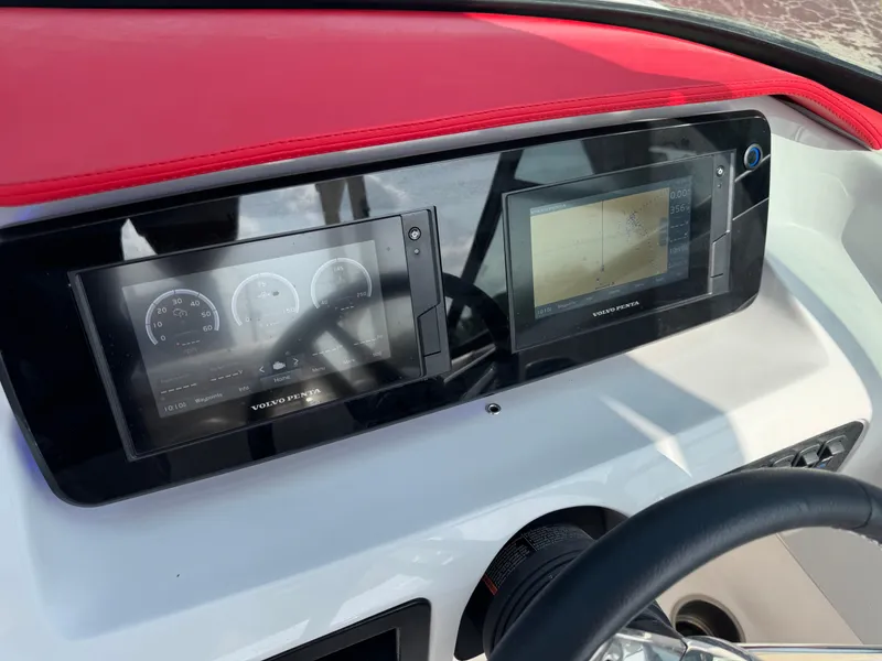 Slide: The Image of Dashboard of 2020 Regal LS2 Surf boat with digital displays and red trim. - 17