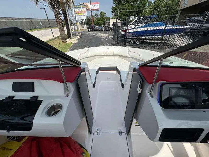 Slide: The Image of 2020 Regal LS2 Surf boat interior with open windshield and red accents. - 19