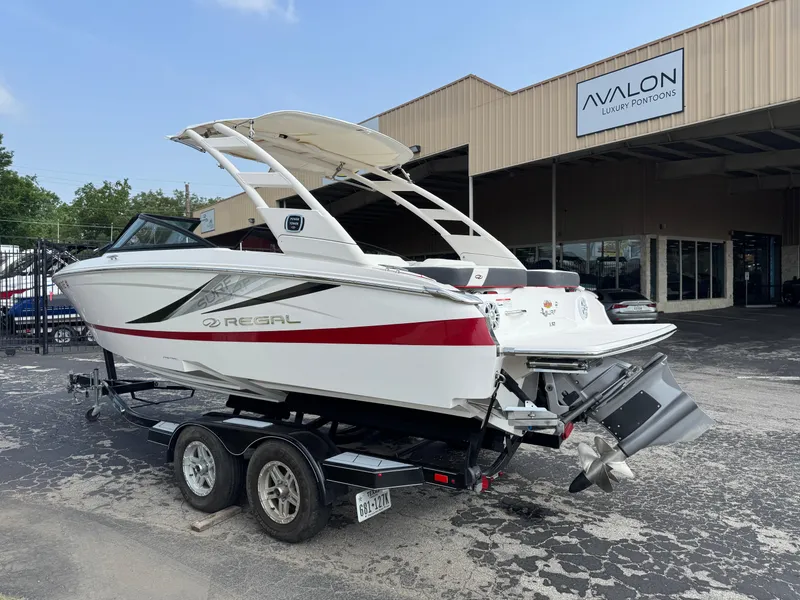 Slide: The Image of 2020 Regal LS2 Surf boat on trailer outside Avalon Luxury Pontoons dealership. - 3