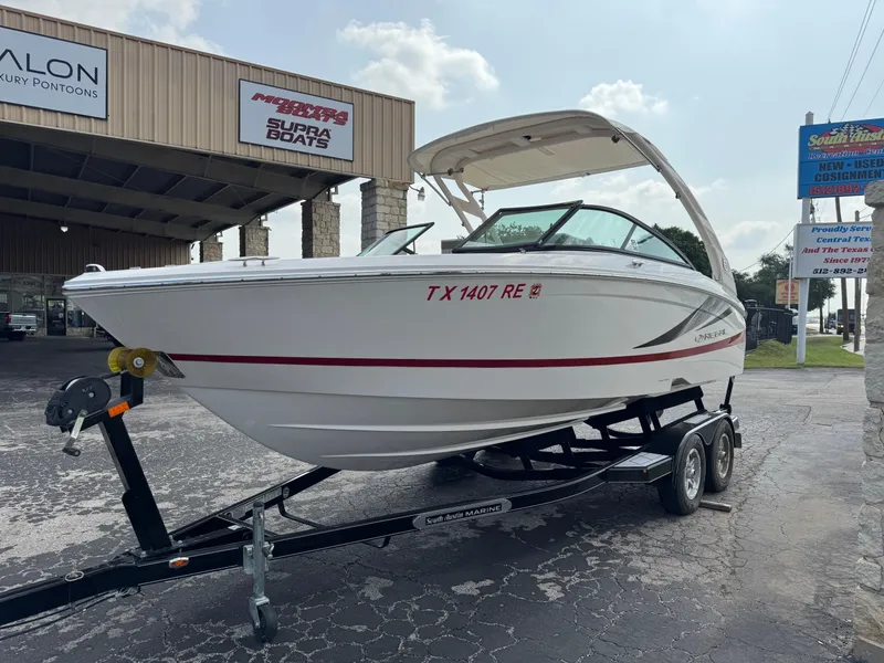 Slide: The Image of 2020 Regal LS2 Surf boat on trailer at dealership, showcasing sleek design and modern features. - 4